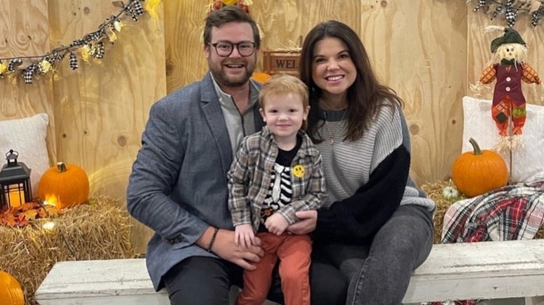 Amy Duggar King posing with husband and son 