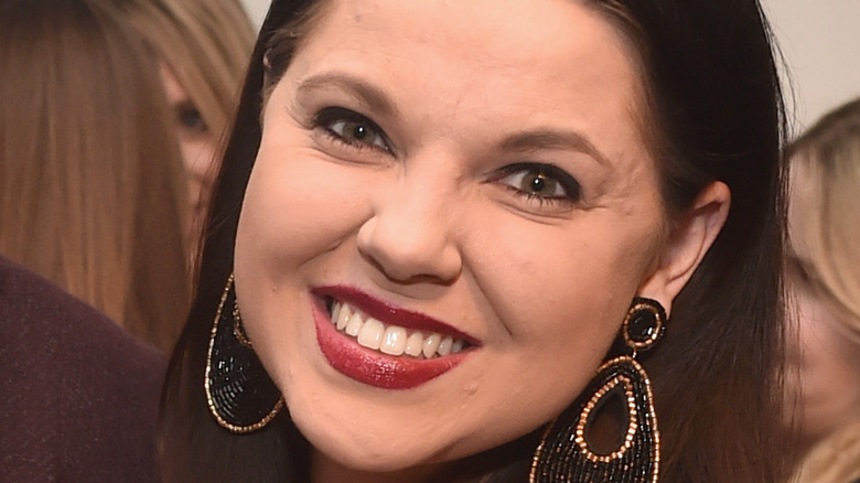 Amy Duggar King smiling on the red carpet