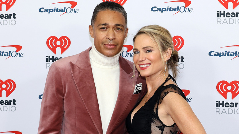 T.J. Holmes and Amy Robach smiling at an event