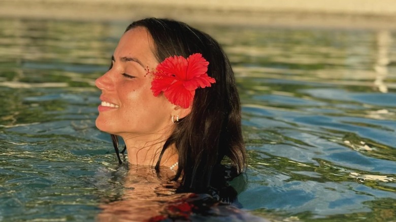 Ana de Armas smiling, eyes closed in ocean