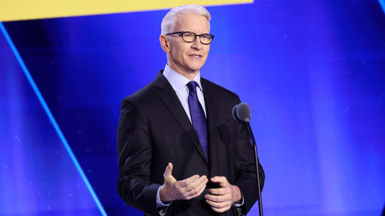 Anderson Cooper speaking at microphone