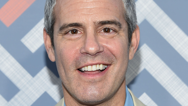 Andy Cohen smiling on red carpet