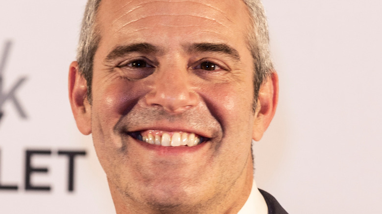 Andy Cohen smiles on the red carpet