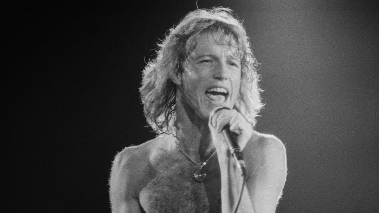 Black and white photo of Andy Gibb performing on stage