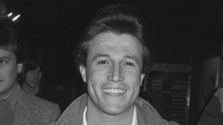 Black and white photo of Andy Gibb smiling in 1985