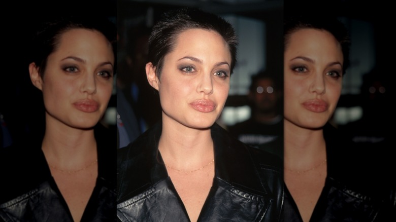 Angelina Jolie poses for a photo at the premiere of Playing God at the Criterion Theater (1997)