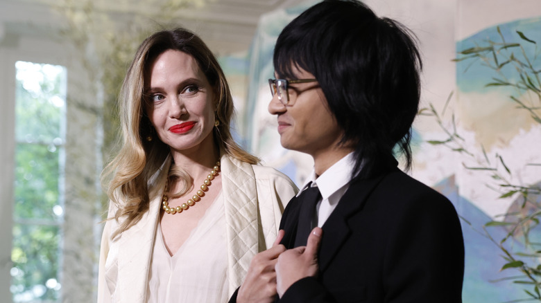 Angelina Jolie (L) smiling at her son Maddox (R)