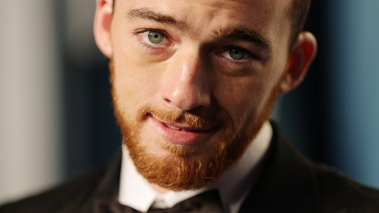 Angus Cloud, wearing a tuxedo on a red carpet