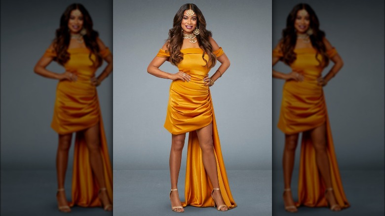 Anila Sajja posing in a dark yellow dress