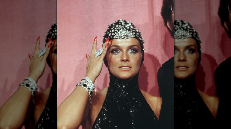 Ann-Margret wearing a black hooded and bejeweled outfit