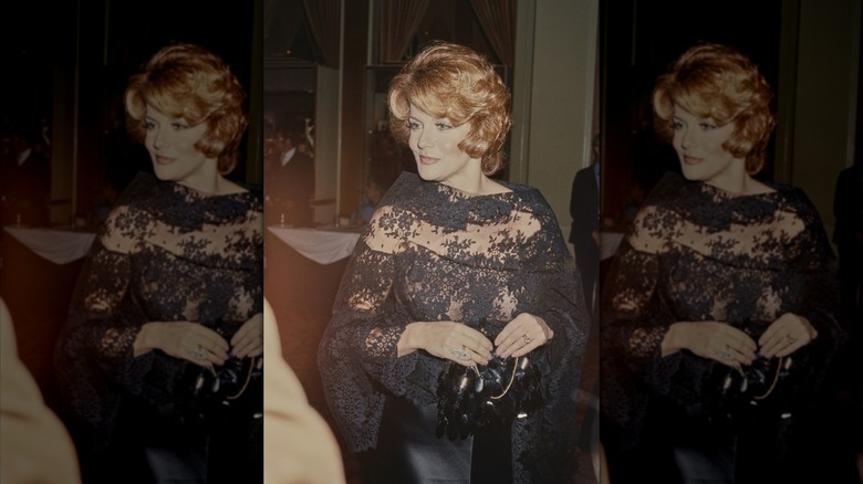 Ann-Margret in a black lace gown with hair in a short bob