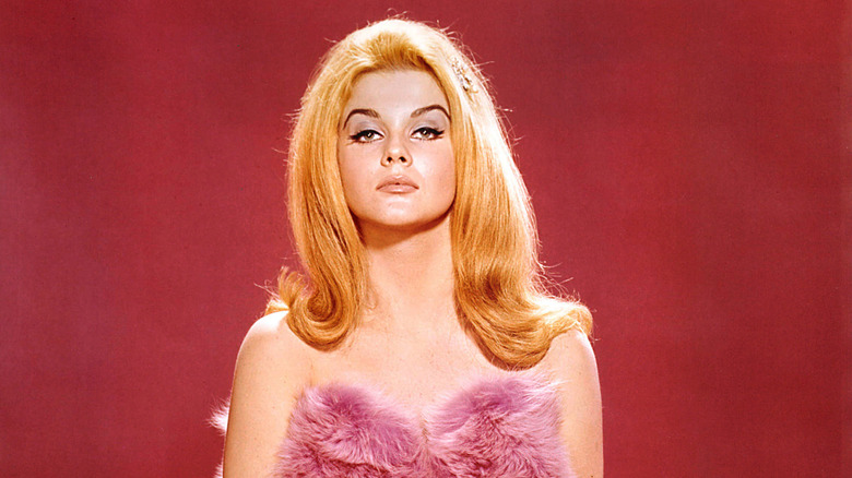Ann-Margret posing in a pink fur top.