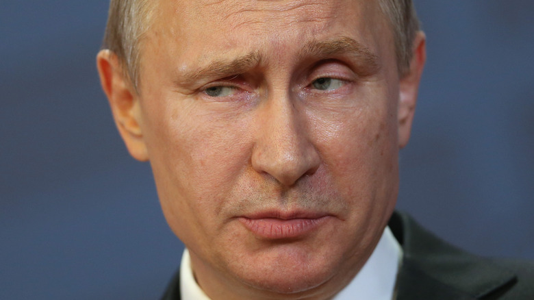 Vladimir Putin looks unconvinced