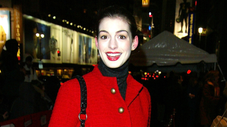 Anne Hathaway red coat white face