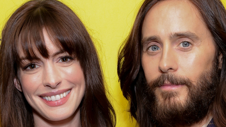 Anne Hathaway and Jared Leto smiling