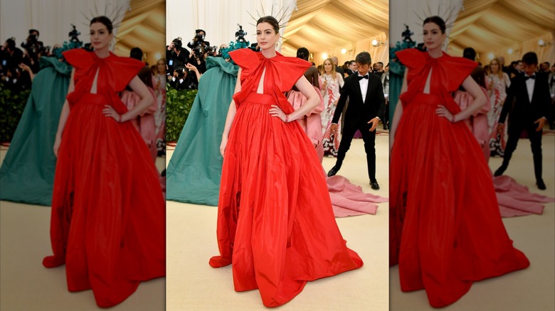 Anne Hathaway wearing a red dress at the 2018 Met Gala
