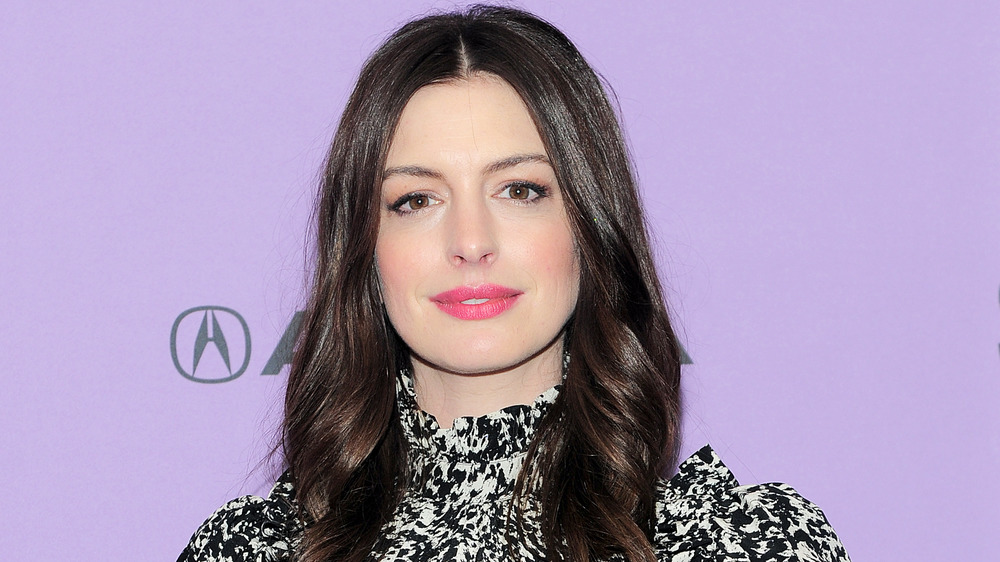 Anne Hathaway smiles at event