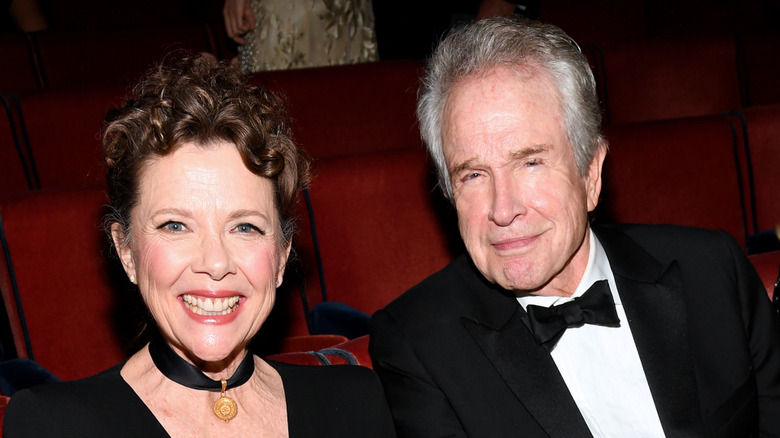 Annette Bening and Warren Beatty sitting and smiling