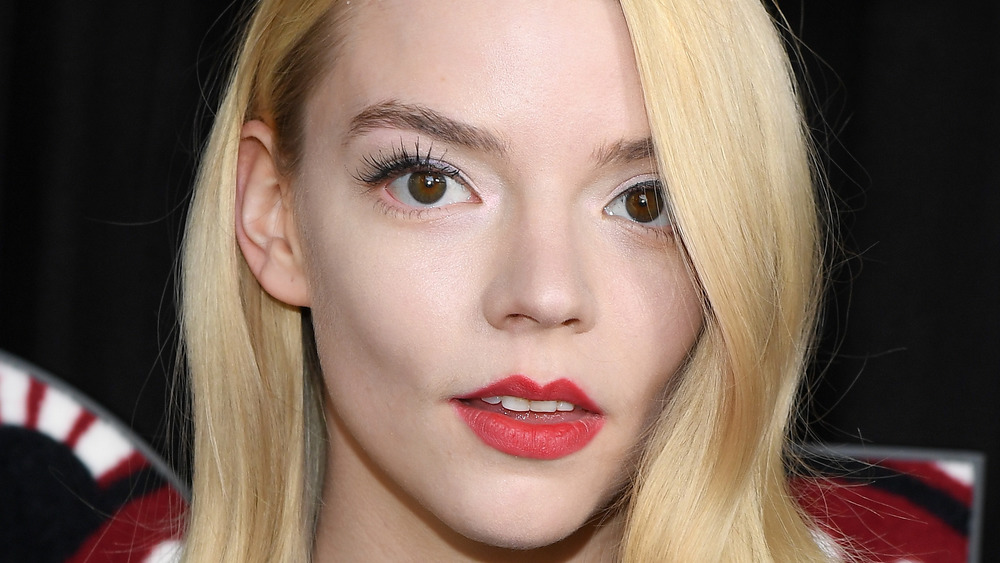 Anya Taylor-Joy grinning with red lip