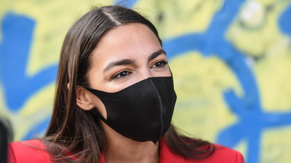 AOC wearing a mask during a campaign event
