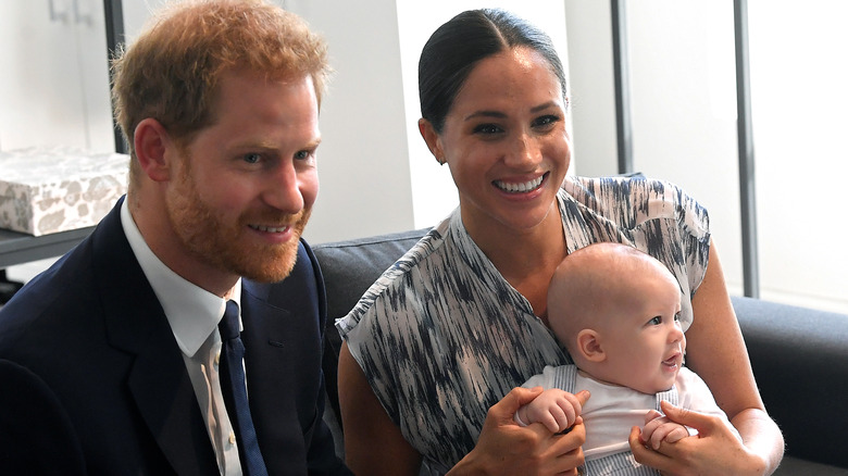 Prince Harry and Meghan Markle holing baby Archie