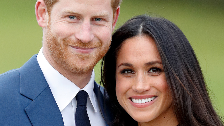 Prince Harry and Meghan Markle pose for the camera.