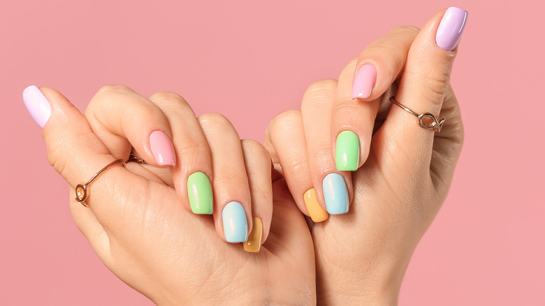 Woman with different colored nail manicure 