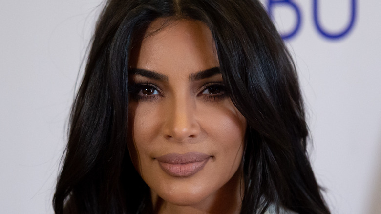 Kim Kardashian smiling at an event. 
