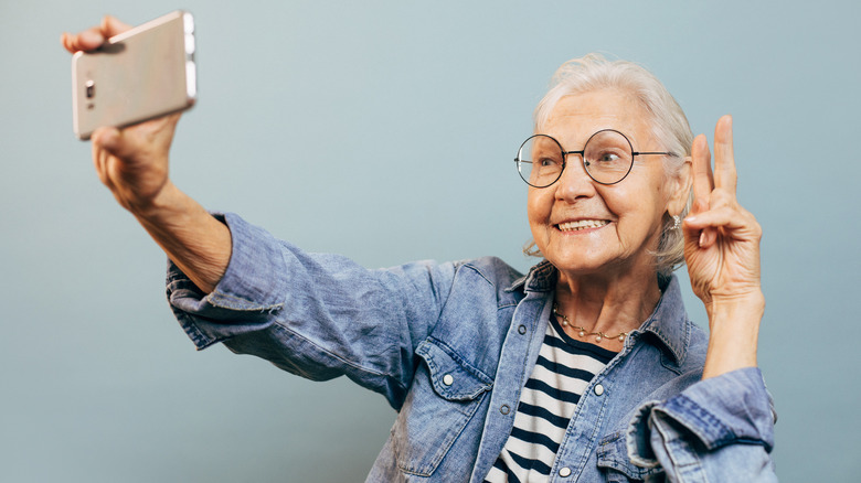 An elderly woman taking a selfie