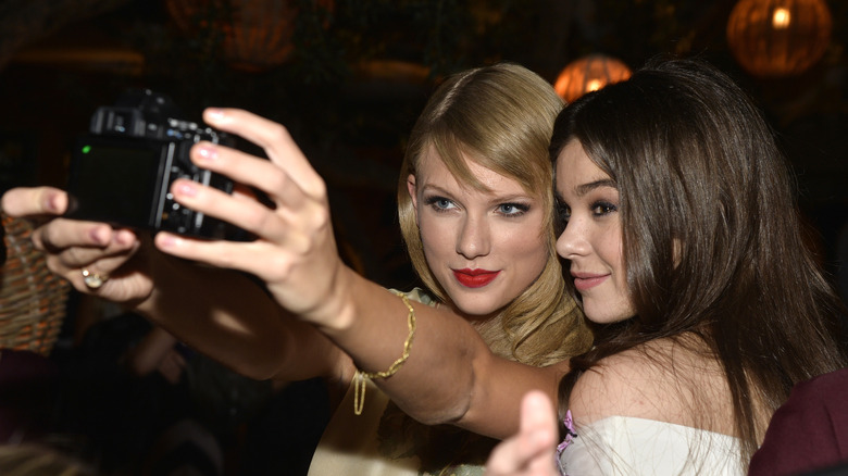 Taylor Swift and Hailee Steinfeld taking a selfie on a camera