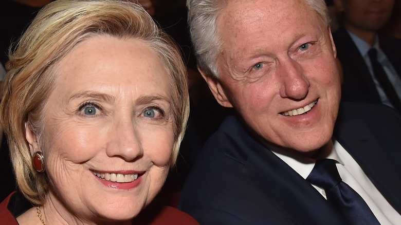 Hillary and Bill Clinton sitting together at an event 