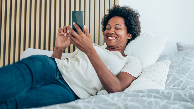 Woman on bed in outside clothes