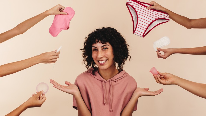 woman with various period products