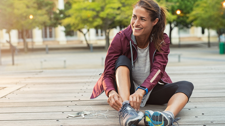 Woman putting on her running shoes