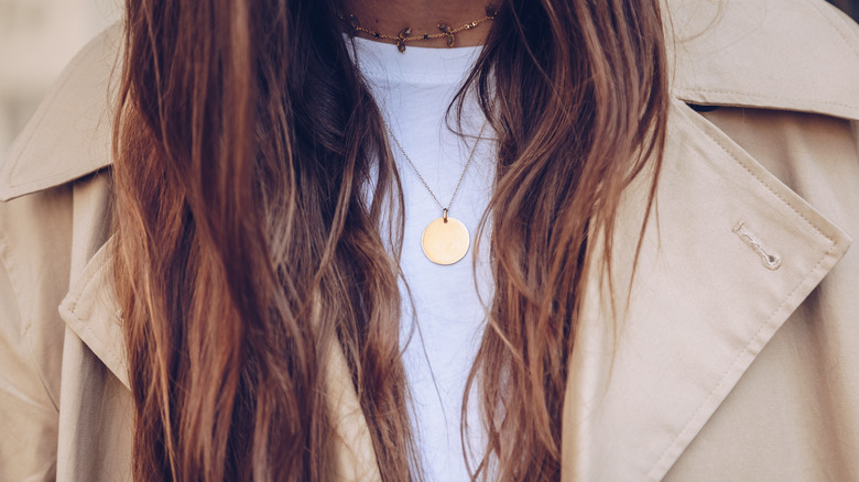 Woman wearing a choker necklace and long necklace