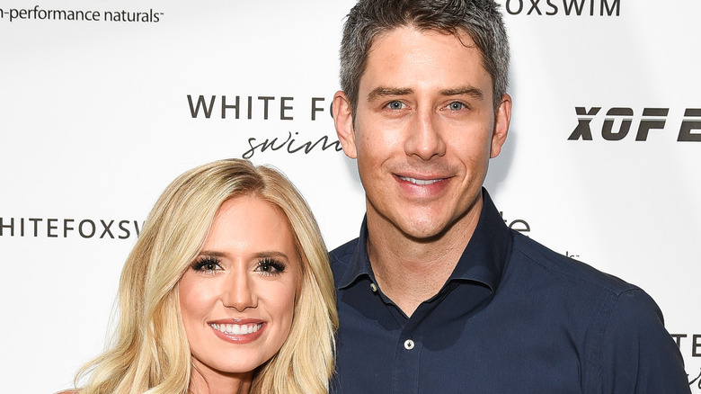 Arie Luyendyk Jr. and Lauren Burnham smile at event
