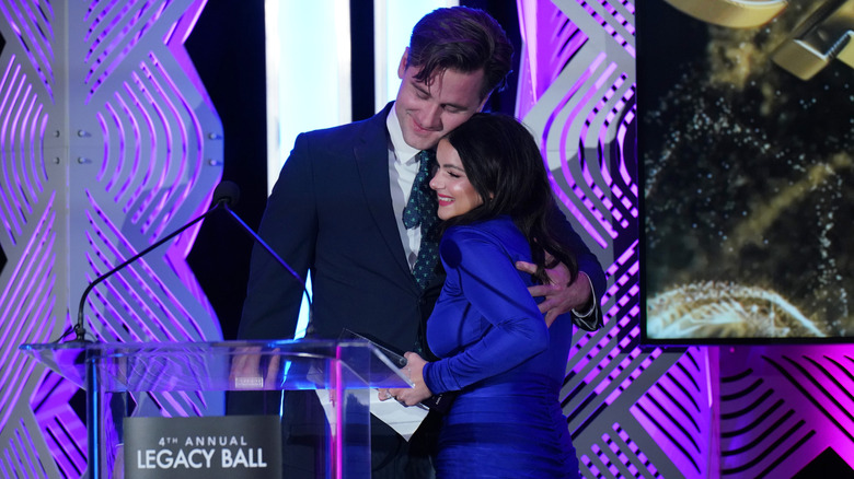 Luke Benward arm around Ariel Winter resting his cheek on the top of her head