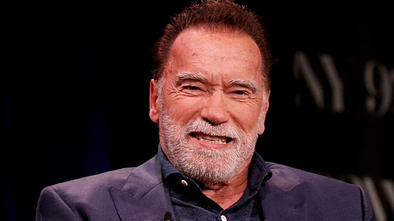 Arnold Schwarzenegger smiling onstage