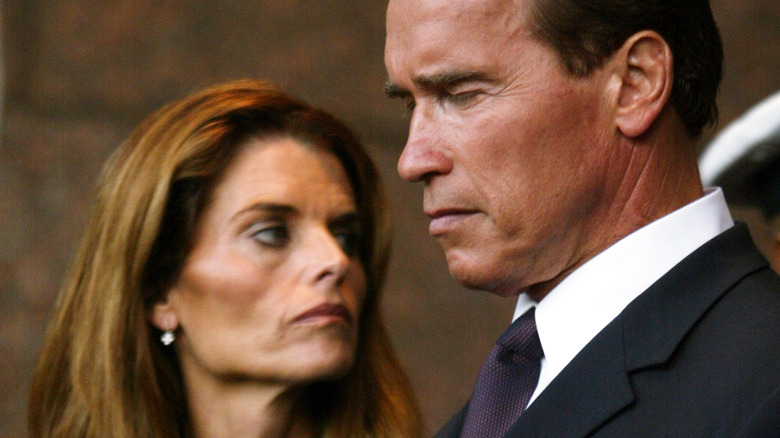 Arnold Schwarzenegger land Maria Shriver scowling