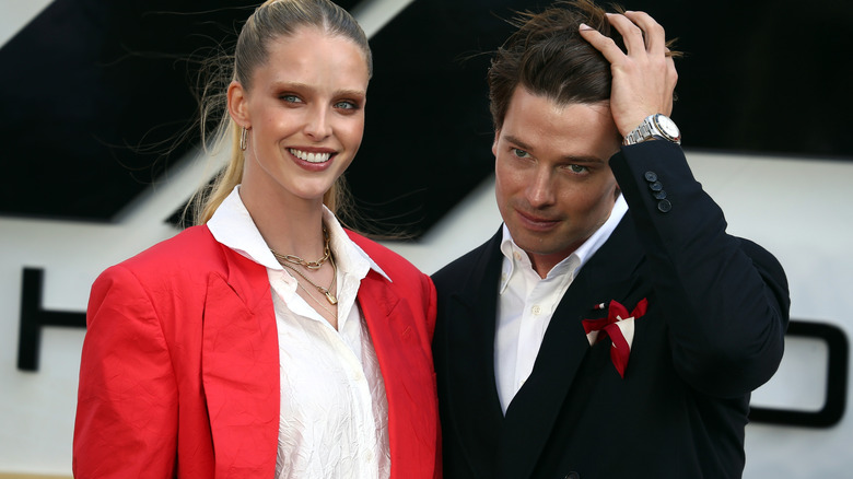 Abby Champion and Patrick Schwarzenegger posing together.