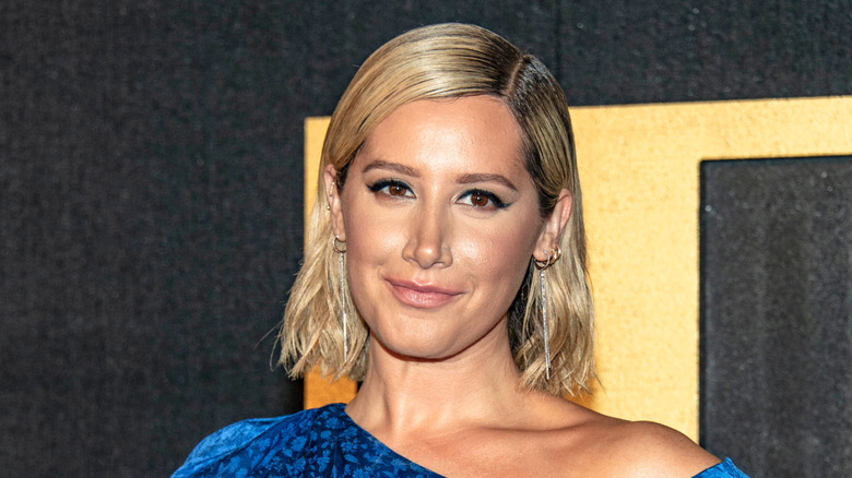 Ashley Tisdale smiling on the red carpet
