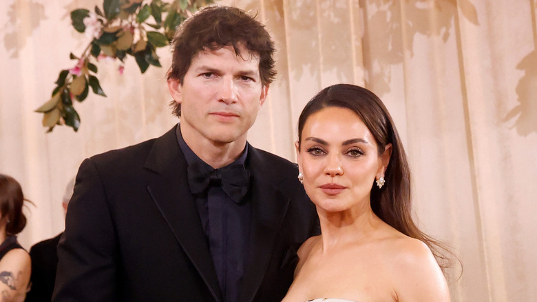 Ashton Kutcher and Mila Kunis posing