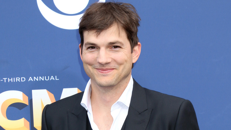 Ashton Kutcher smiling at event