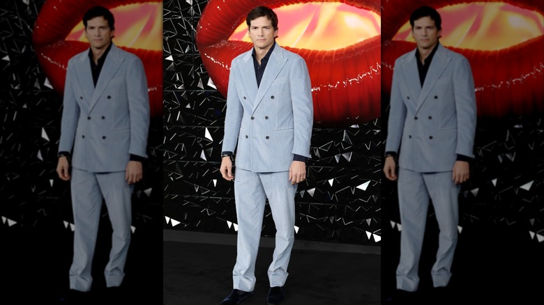 Ashton Kutcher posing in a blue suit