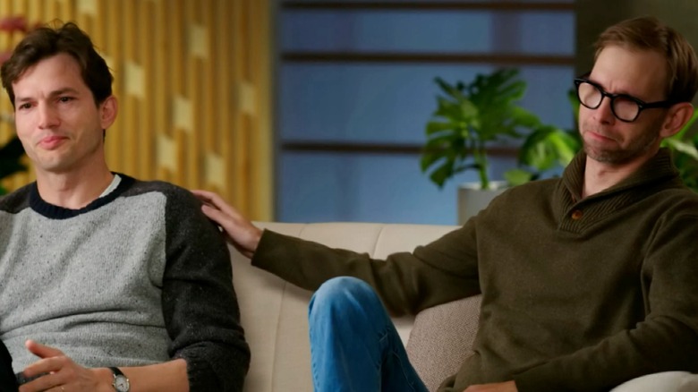 Ashton Kutcher and Michael Kutcher sit on the couch together, teary-eyed