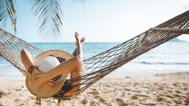 Person in a hammock on a Thailand beach 