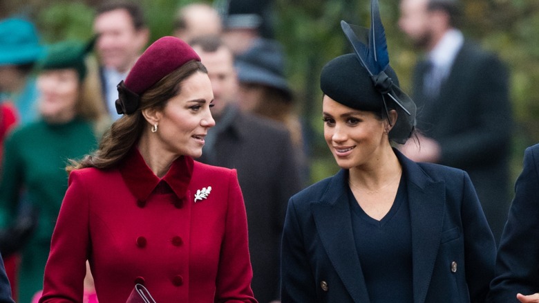 Kate Middleton talking to Meghan Markle