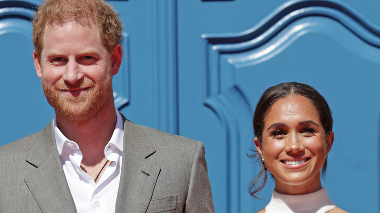 Prince Harry and Meghan Markle smiling for photos in Germany