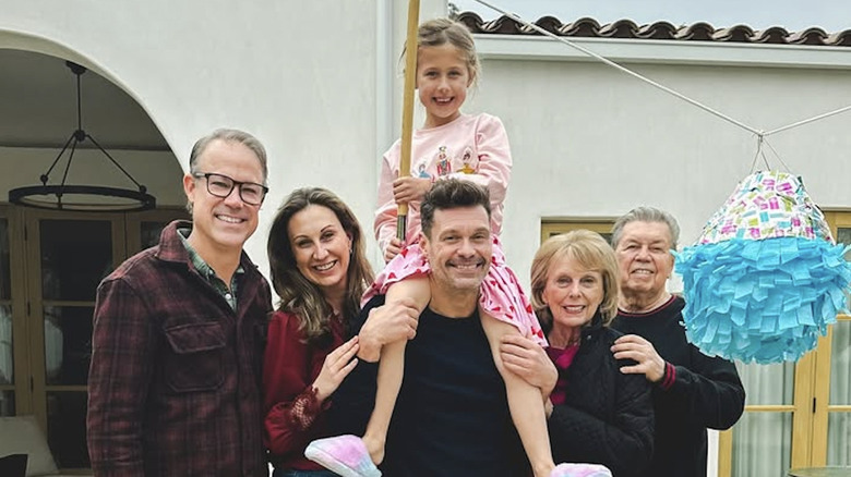 Ryan Seacrest and his family smiling