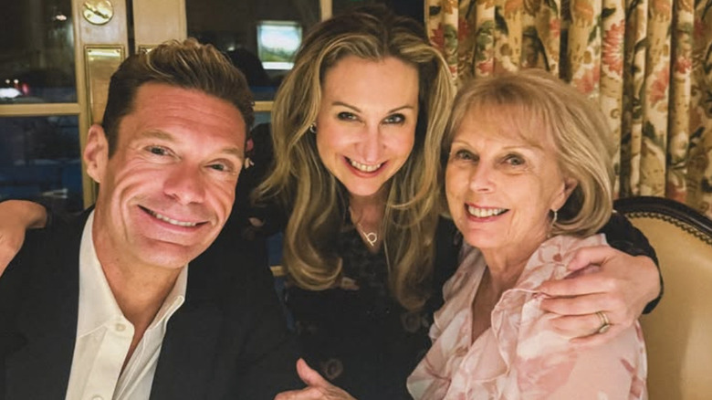 Meredith Seacrest Leach embracing Ryan Seacrest and Connie Seacrest